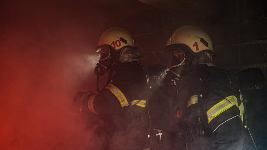 pexels photo 6246128 Firefighters in full gear navigating through smoky environment, showcasing bravery and teamwork.
